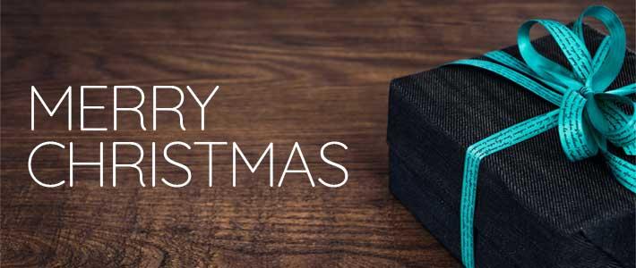 A Christmas box wrapped in black wrapping paper is tied together by a light blue strand. The text on this image reads "Merry Christmas".